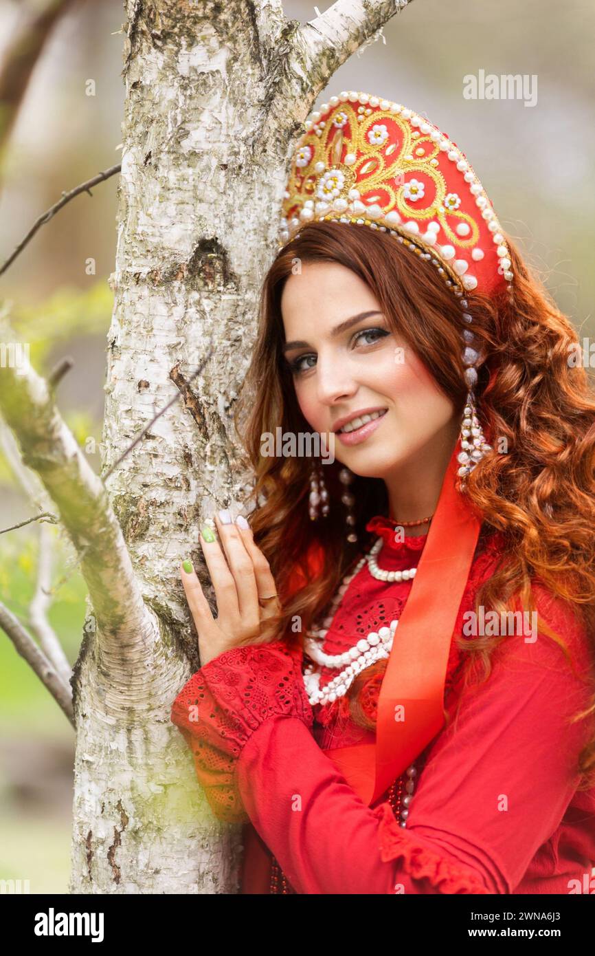 russian girl in traditional russian sarafan and kokoshnik embroidering ...