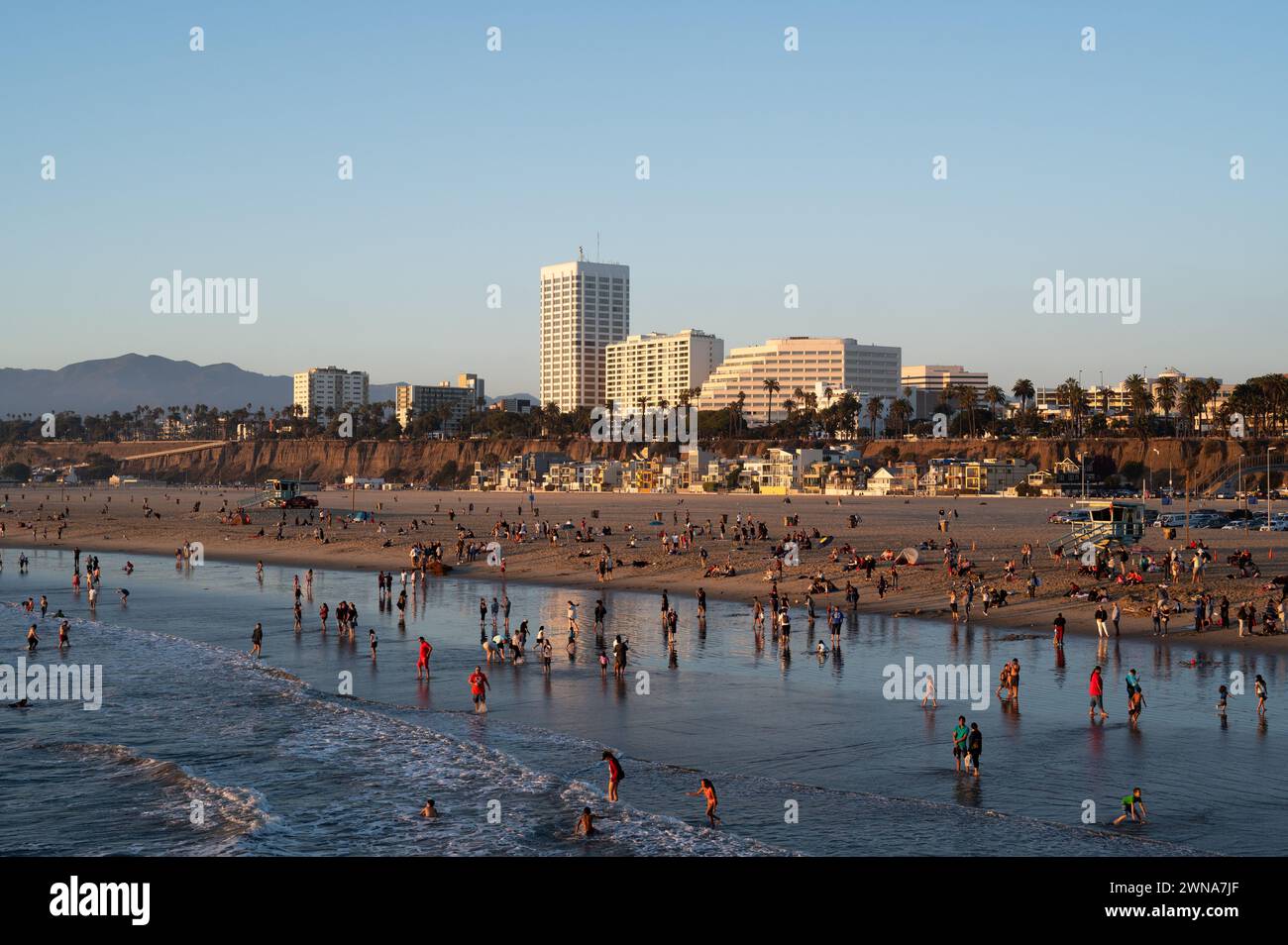 SANTA MONICA, CALIFORNIA, USA: People flock to the beach next to the world famous Santa Monica Pier in Santa Monica, California. Stock Photo