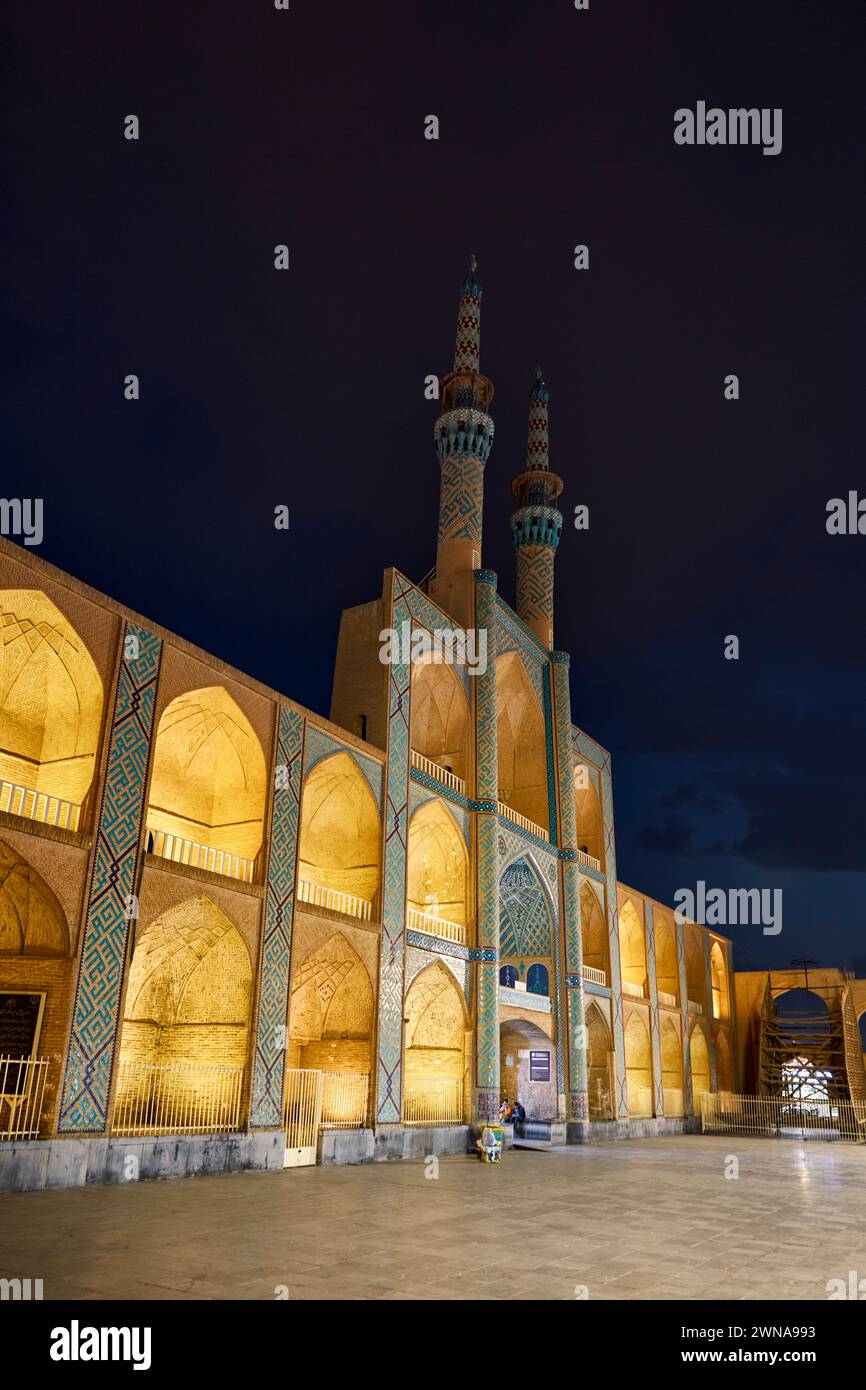 Takyeh (building where Shia Muslims gather to mourn Husayn's death) and minarets of the Amir Chakhmaq Complex illuminated at night. Yazd, Iran. Stock Photo