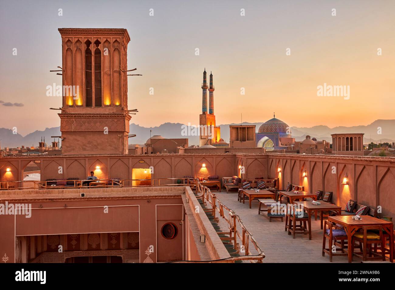 Rooftop terrace of the Cafe Nardoon in the historical Fahadan Neighborhood at sunset. Yazd, Iran. Stock Photo