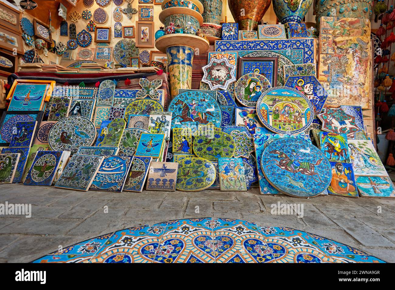A selection of handmade pottery and ceramics displayed in a gift shop in the historical Fahadan Neighborhood of Yazd, Iran. Stock Photo