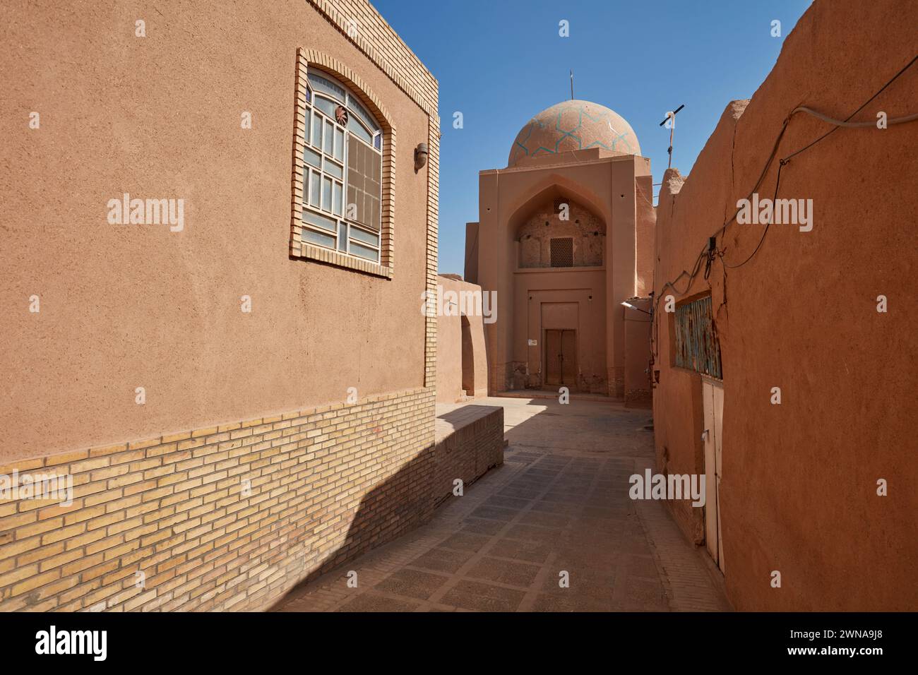 Traditional adobe buildings on a narrow street in the historical Fahadan Neighborhood of Yazd, Iran. Stock Photo