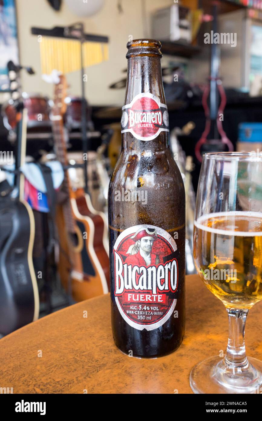 Bucanero beer in front of guitars in a bar in Havana. Stock Photo