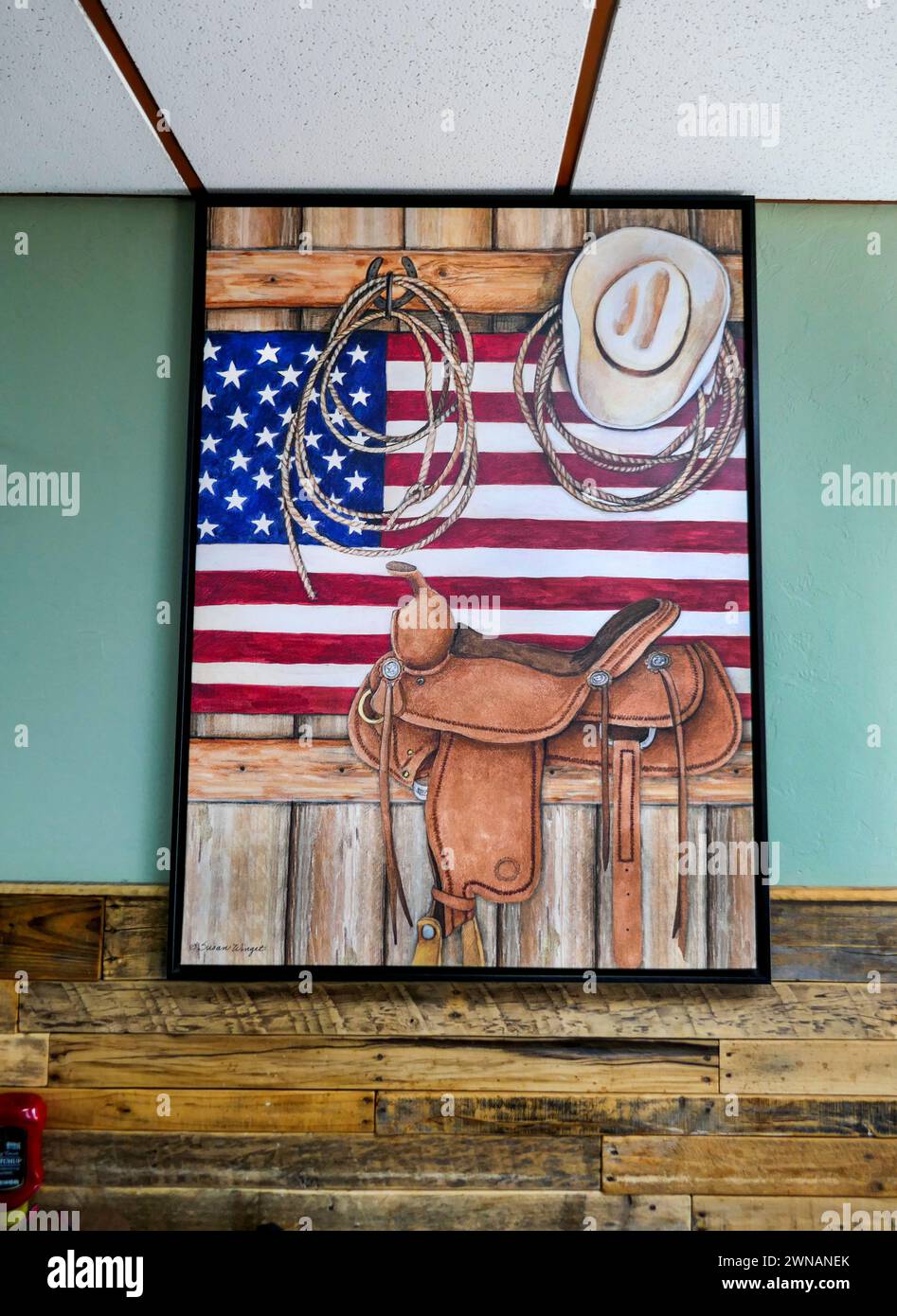 Cowboy painting and other Western decorations in a local restaurant in North Central Florida. Painting is by artist Susan Winget. Stock Photo