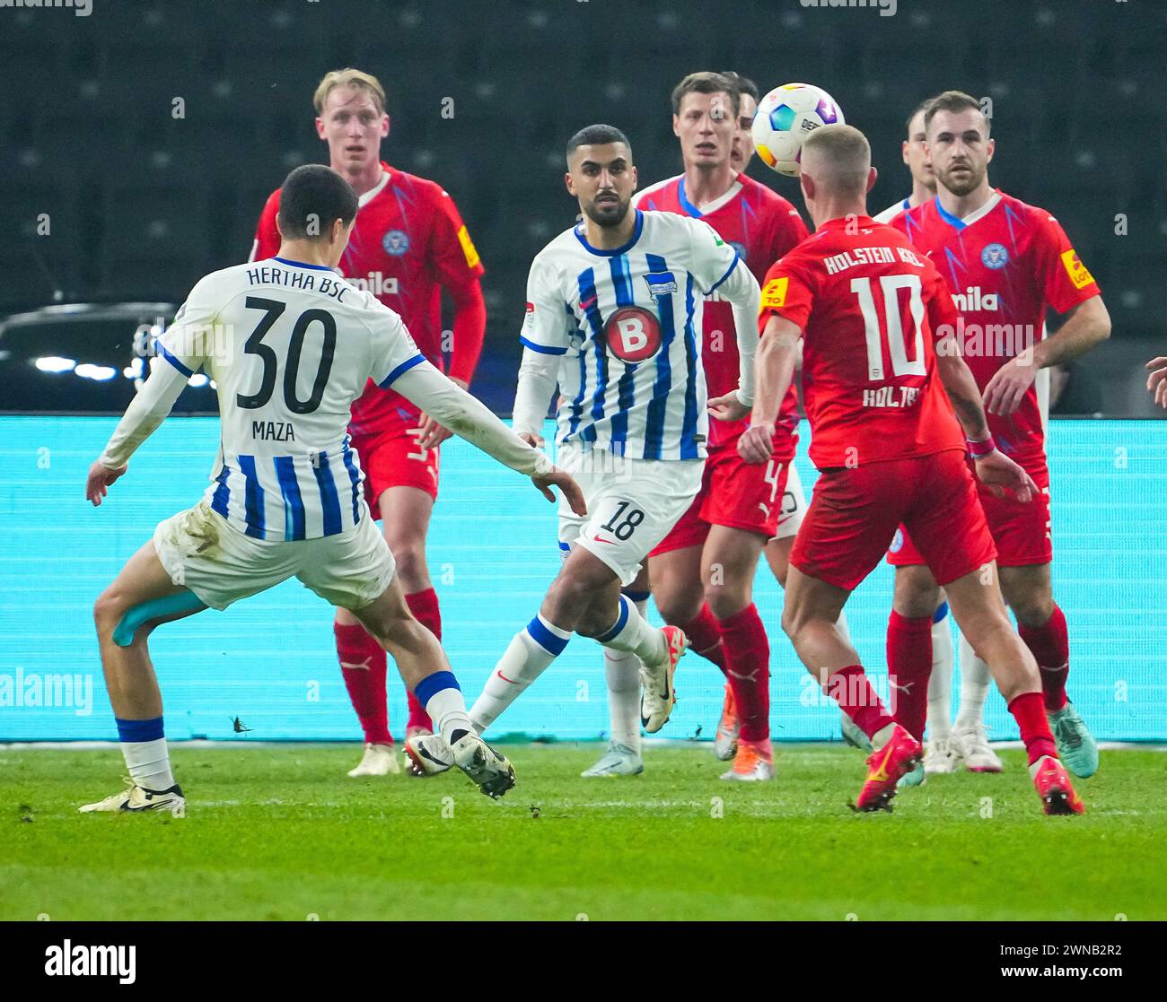 01 March 2024, Berlin: Soccer, Bundesliga 2, Matchday 24, Hertha BSC - Holstein Kiel, Olympiastadion: Hertha's Aymane Barkok (3rd from left) and Ibrahim Maza (left) against Holstein Kiel's Colin Kleine-Bekel (2nd from left), Patrick Erras, Marco Komenda (right) and Lewis Holtby (2nd from right). Photo: Soeren Stache/dpa - IMPORTANT NOTE: In accordance with the regulations of the DFL German Football League and the DFB German Football Association, it is prohibited to utilize or have utilized photographs taken in the stadium and/or of the match in the form of sequential images and/or video-like p Stock Photo