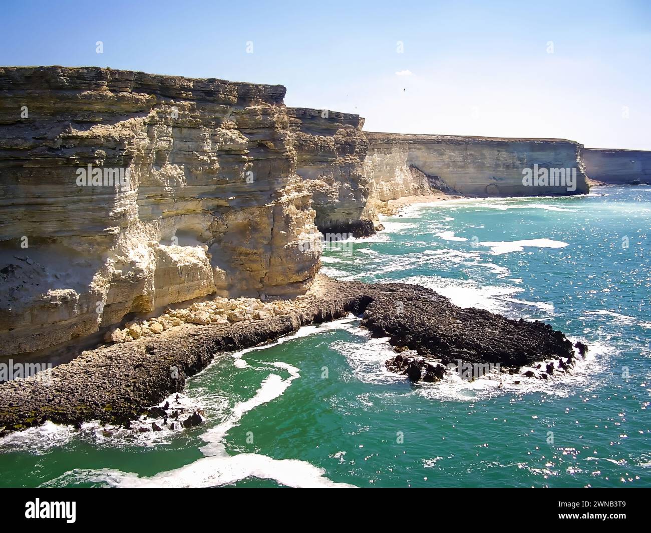 Powerful ocean waves meet a dramatic rocky coastline, creating a ...