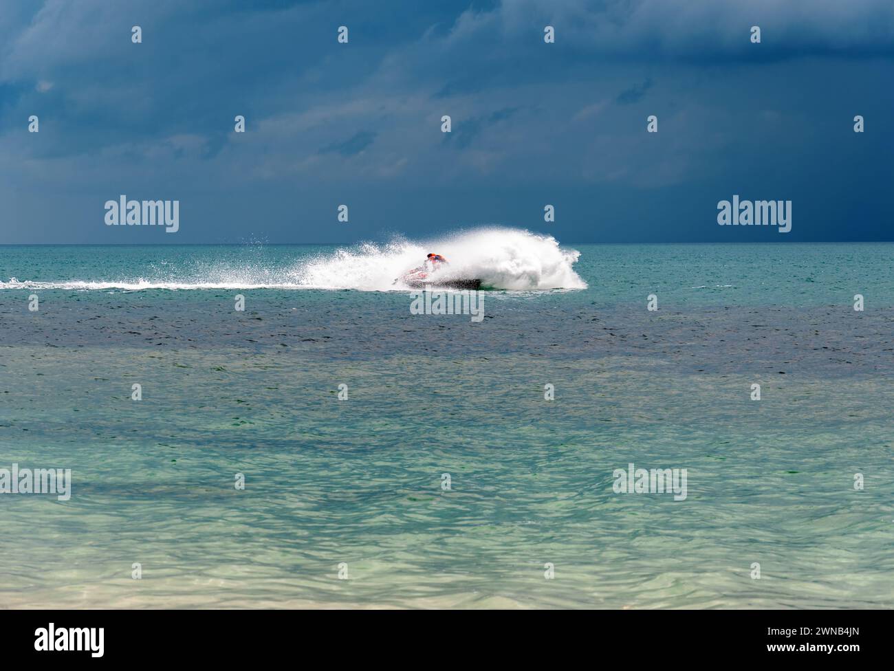 The driver of the jet ski drives a jet ski at high speed, rides at ...
