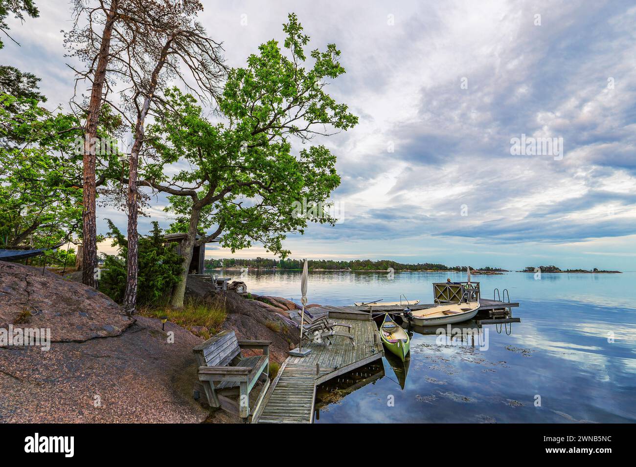 Baltic Sea coast with landing stage and boats near Oskarshamn in Sweden. Stock Photo