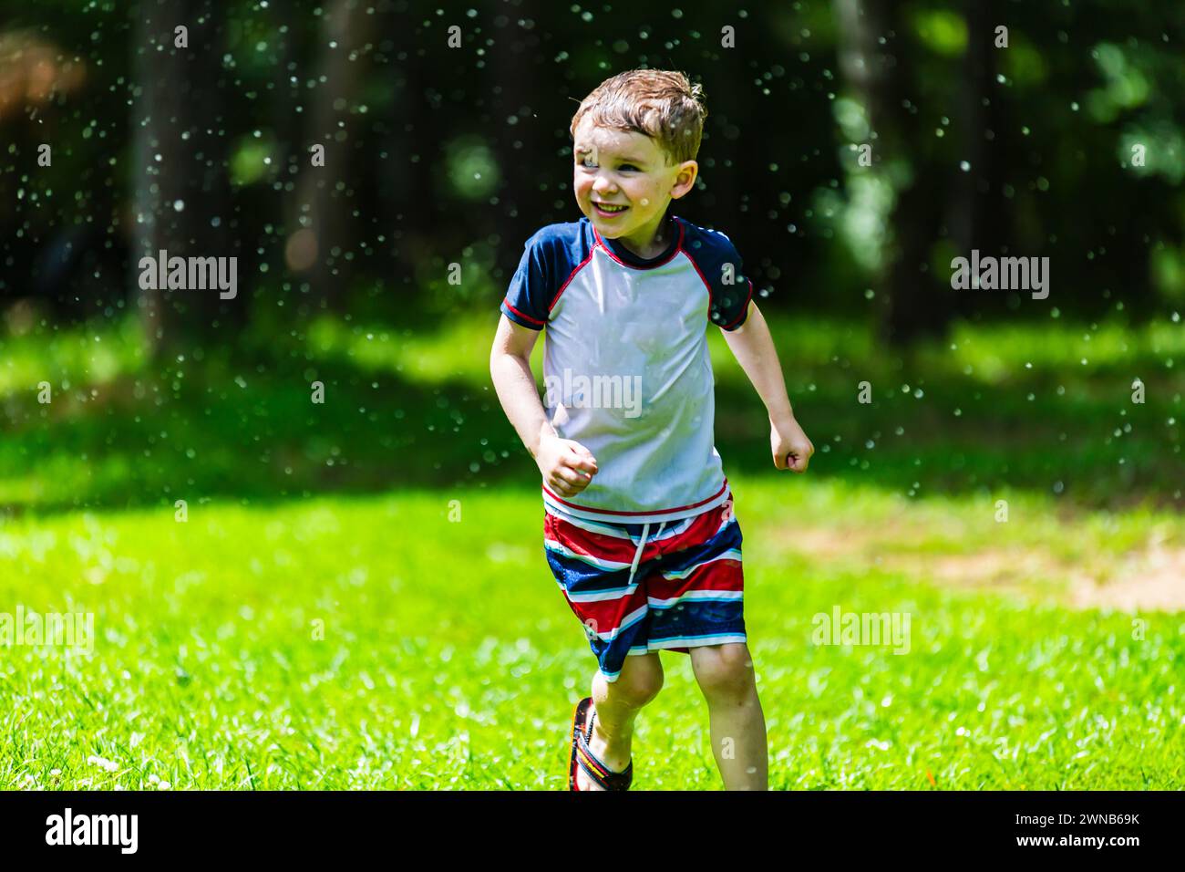 Boy running in water hi-res stock photography and images - Alamy