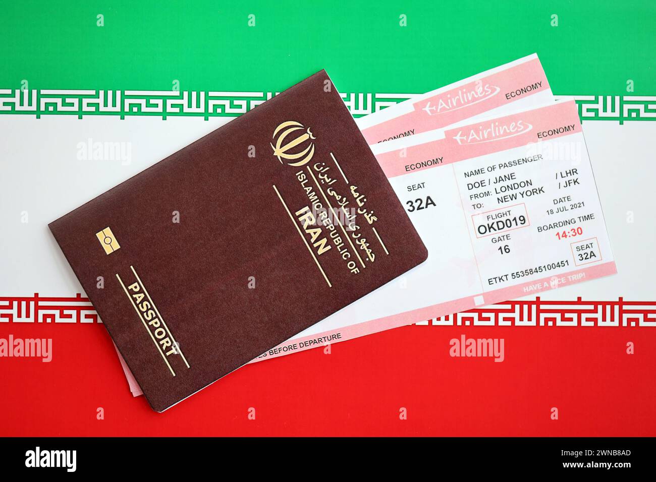 Red Islamic Republic of Iran passport with airline tickets on Iranian