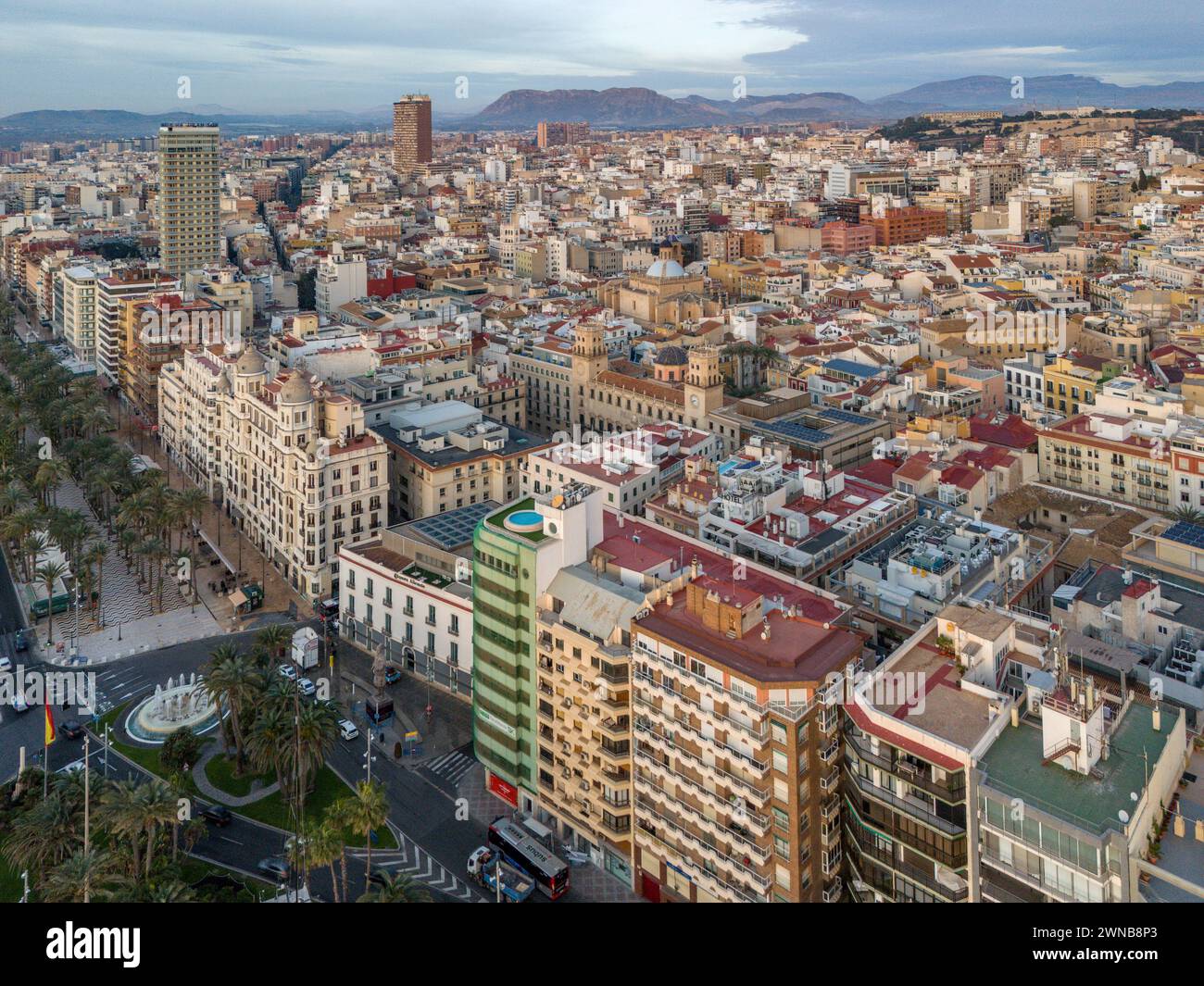 A bustling urban landscape with skyscrapers and lush trees Alicante