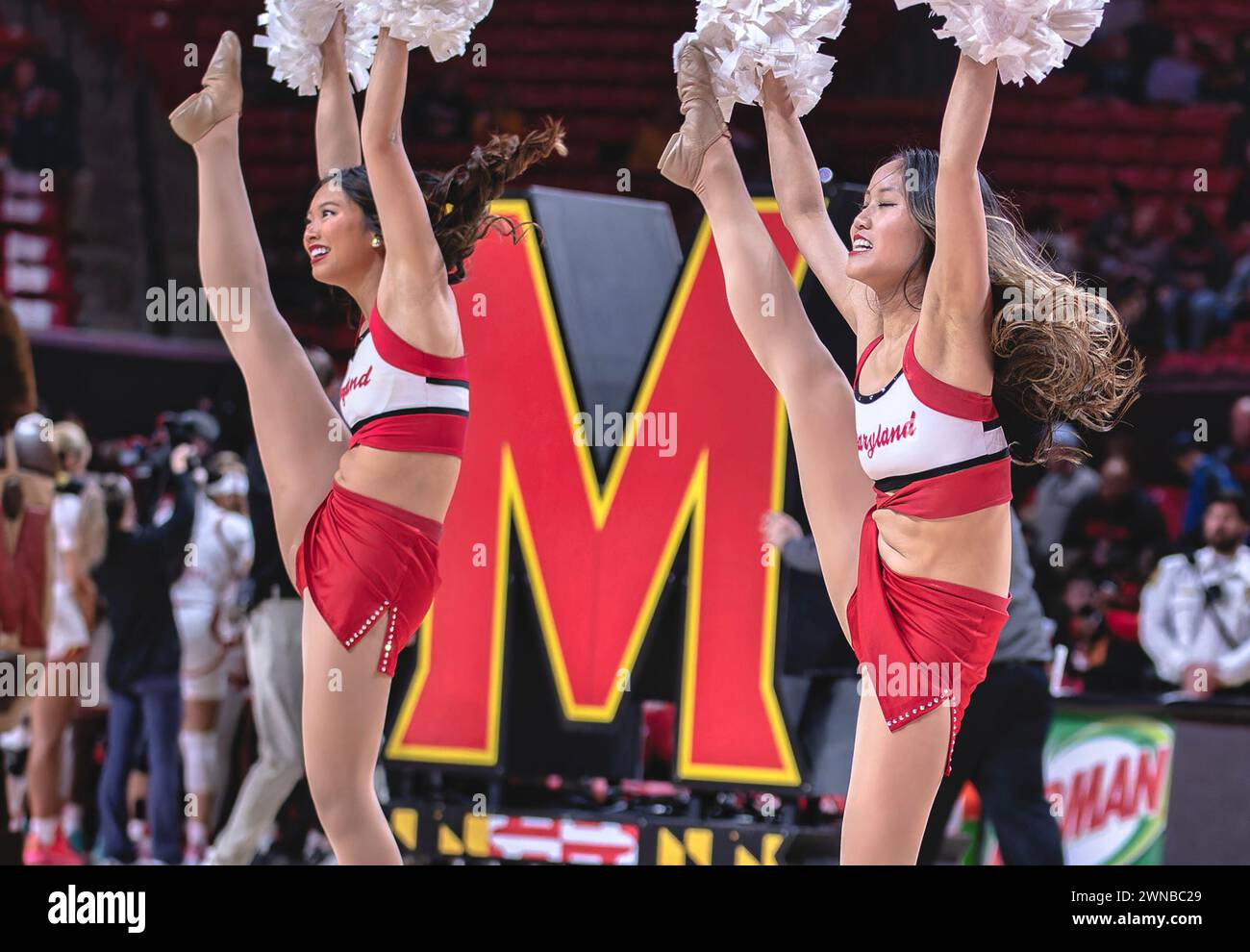 Cheerleaders in synch at a basketball game Stock Photo