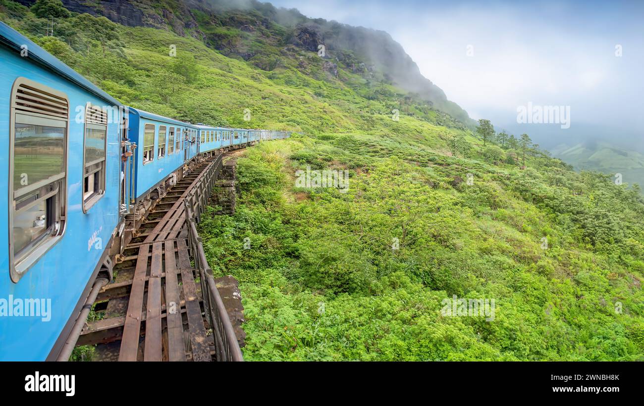 A train meanders through the tea plantations in the highlands of Sri Lanka Stock Photo