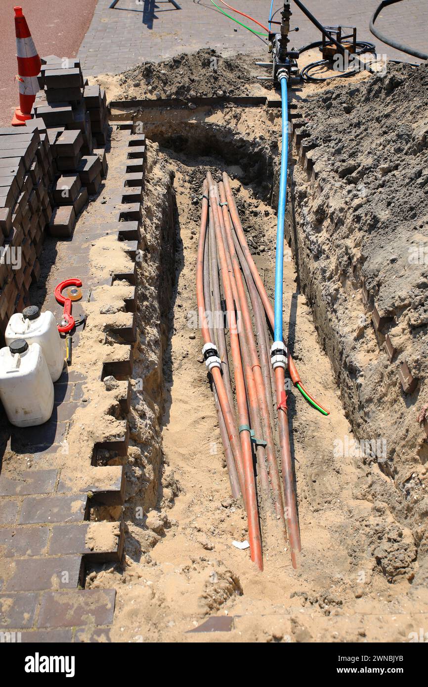 Installation and connecting fibre optic cables to neighbouring houses Stock Photo