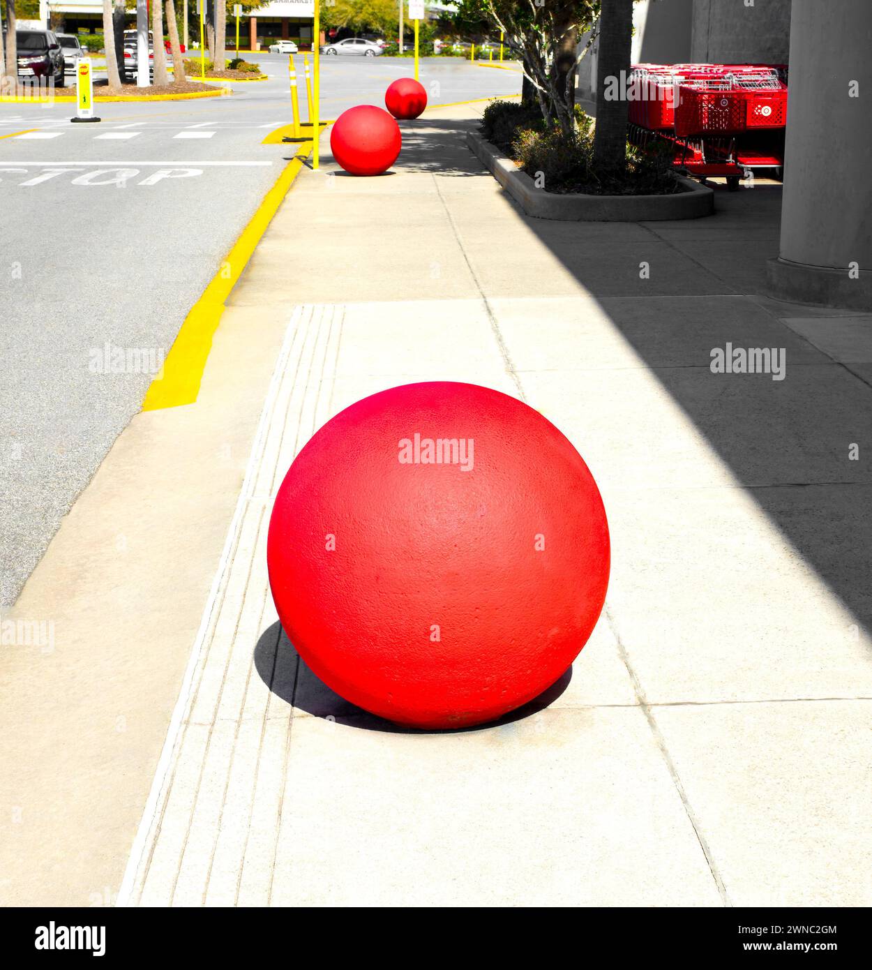 Ocala, Florida 2-27-2024 giant red concrete sphere, ball, bollard in front of the brick and mortar target retail store on sidewalk with cart or buggy Stock Photo