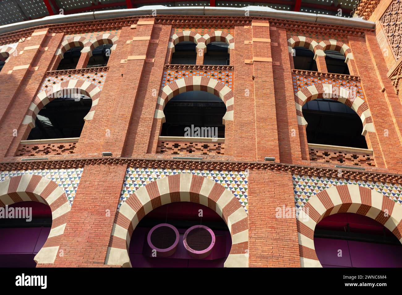 Spanish architecture made by red bricks, Barcelona Spain. Balcony with ...