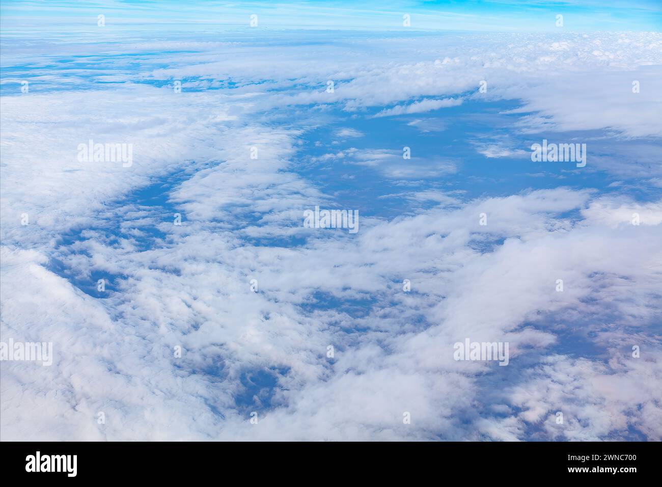 Blue sky with white clouds over the Earth as seen through window of an ...