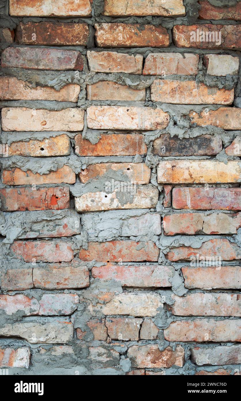 Brick wall background. Urban rustic texture. Antique house exterior wall. Vintage abandoned building architecture. Red brick construction. Red and whi Stock Photo