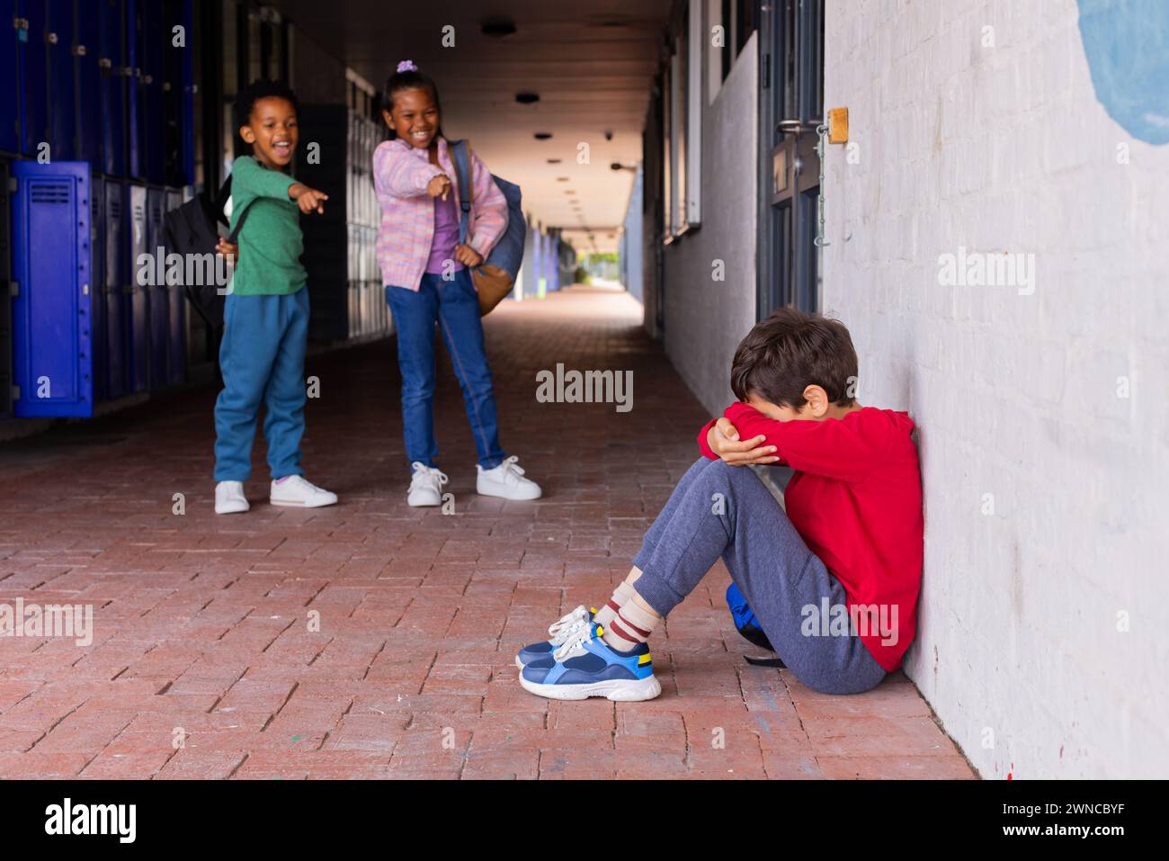 This highlights a serious social issue, emphasizing the impact of bullying in a school setting Stock Photo