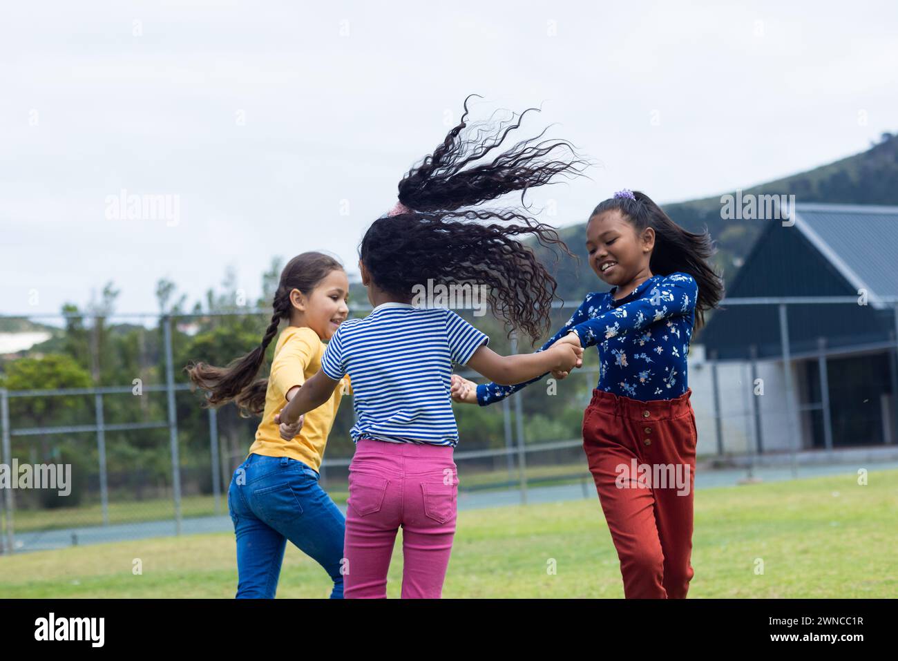 School girls holding hands hi-res stock photography and images - Alamy