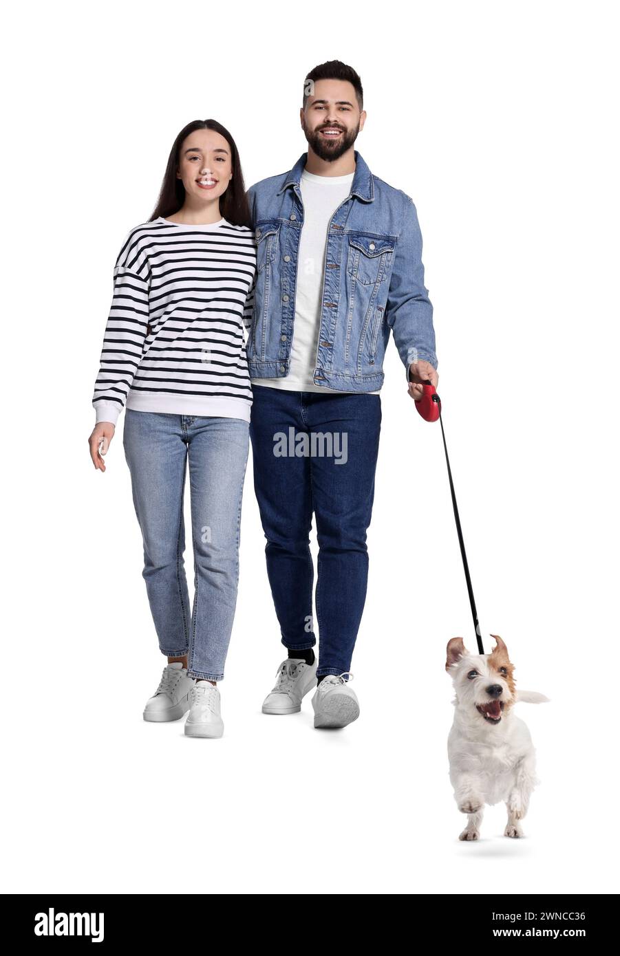 Happy couple walking with dog on white background Stock Photo - Alamy