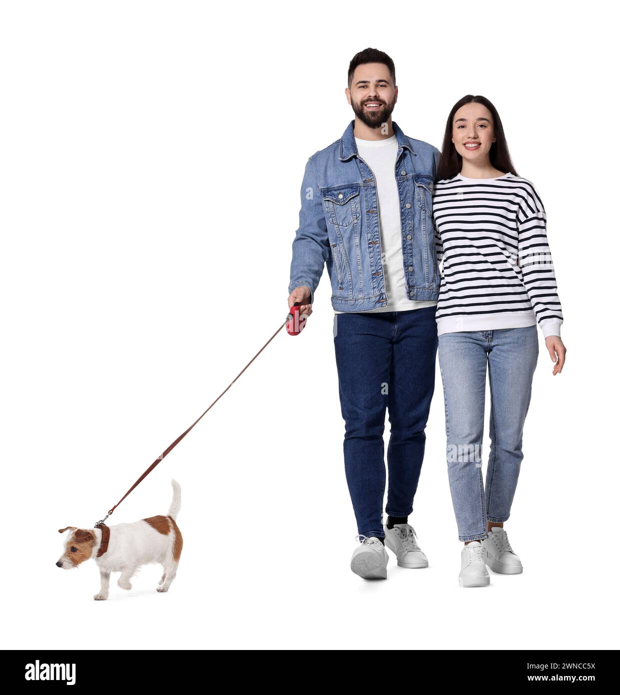 Happy couple walking with dog on white background Stock Photo - Alamy
