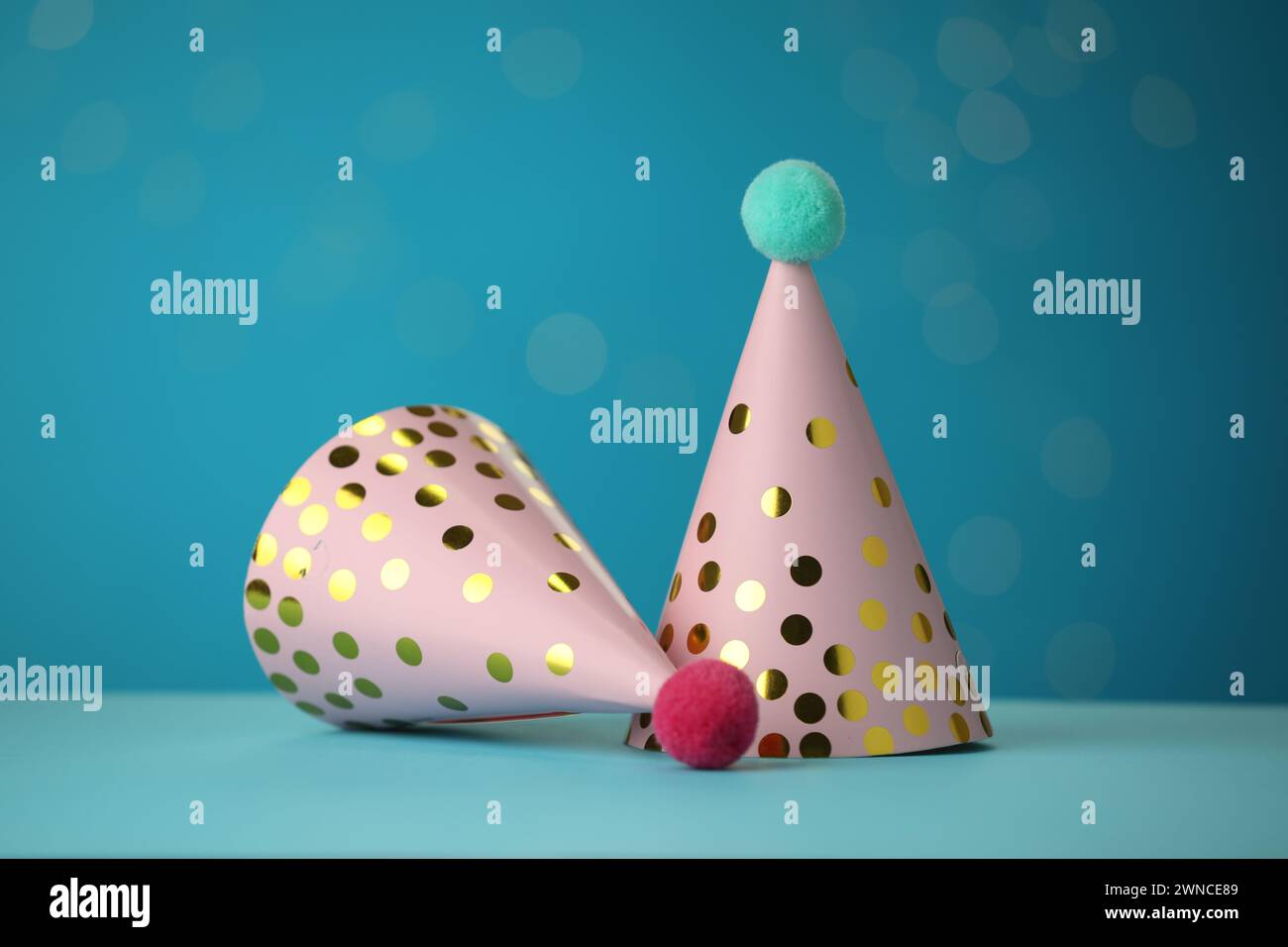 Beautiful party hats on light blue background Stock Photo - Alamy
