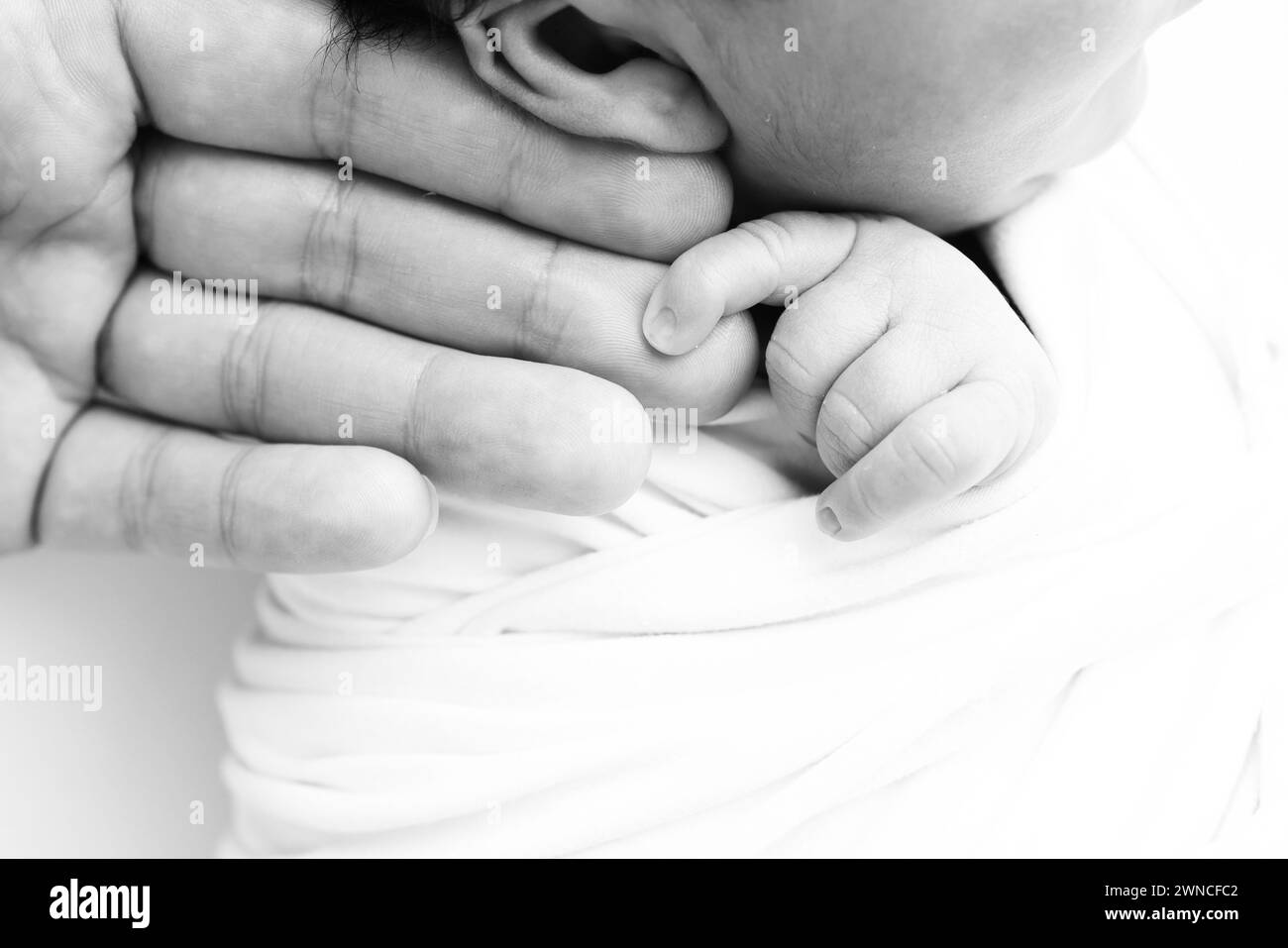 Black and white Photo of Newborn baby after birth tightly holding ...