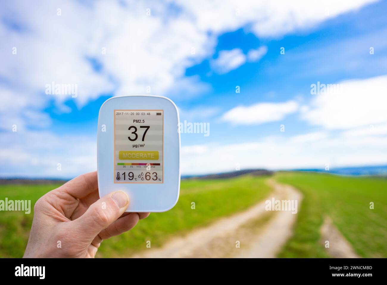 Hand holding air quality monitor Stock Photo