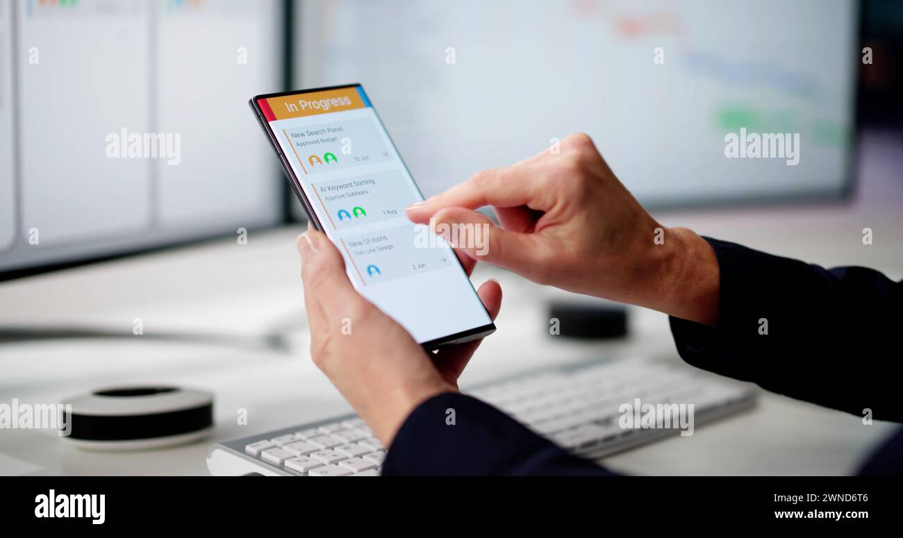 Digital Calendar Schedule Software In Office. Scrum Mobile Phone App Stock Photo