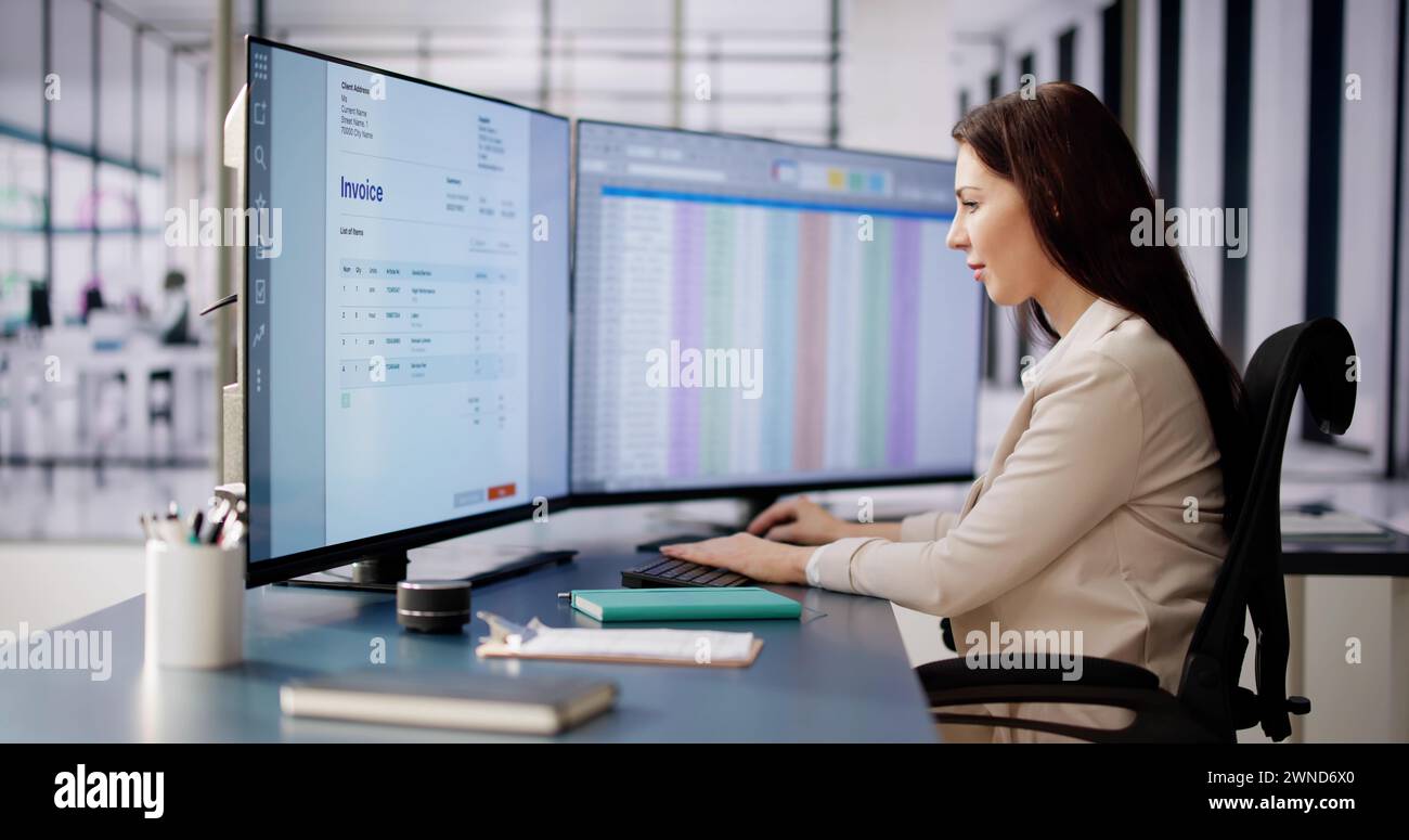 Accountant Using E Invoice Software At Computer In Office Stock Photo