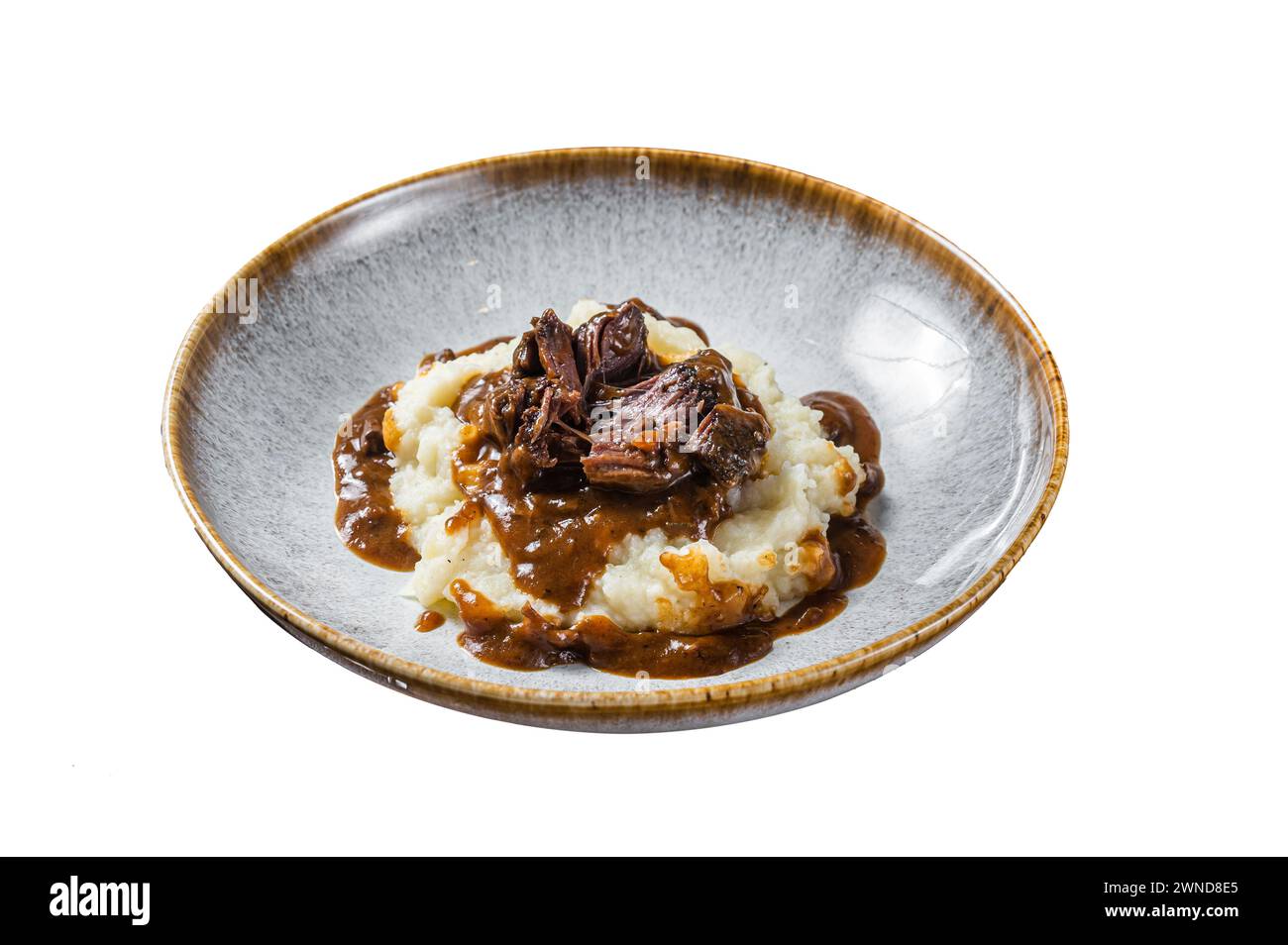 Slow cooked beef cheeks in red wine sauce with mashed potato. Isolated