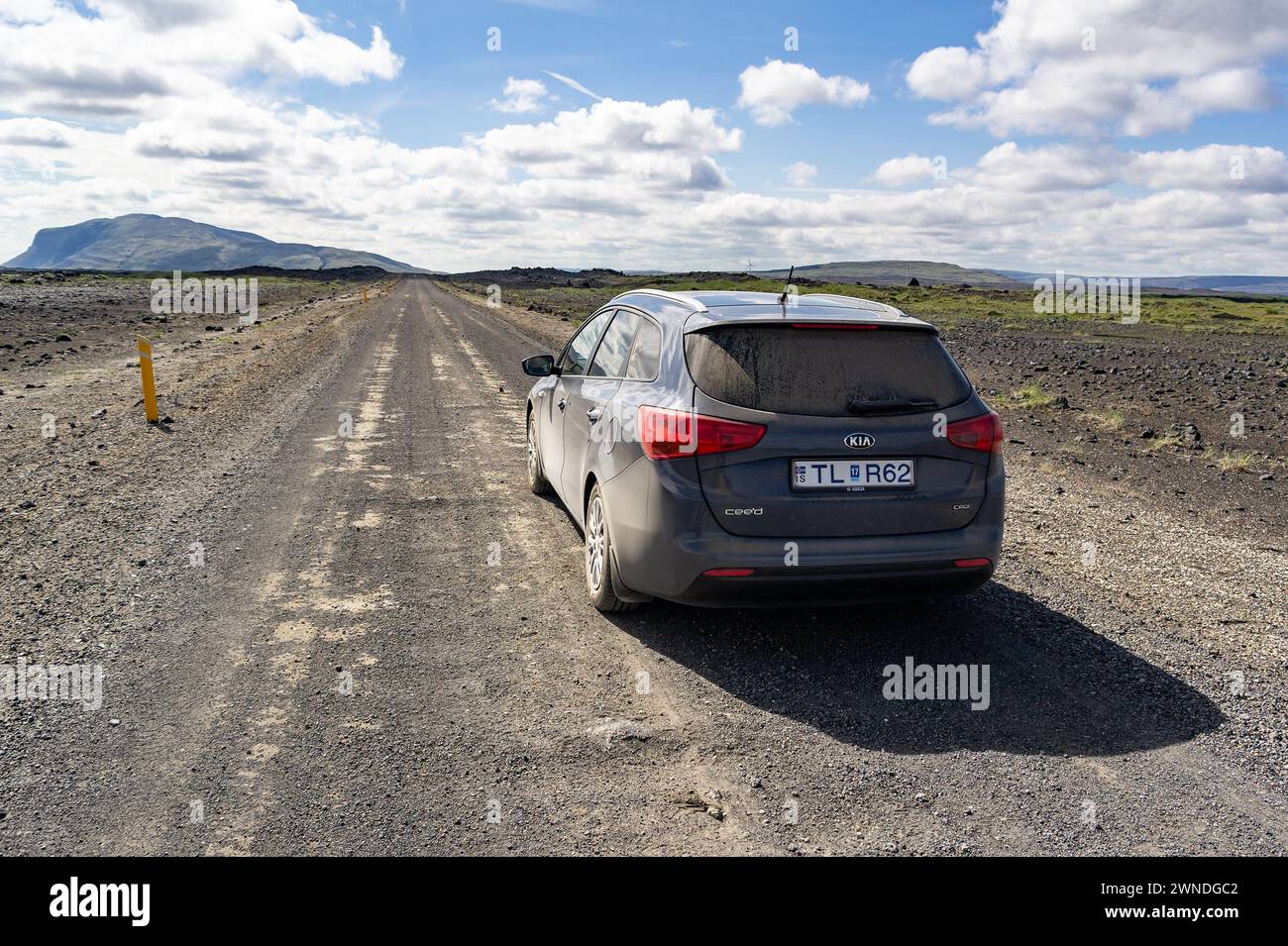 ICELAND - JUNE 29, 2014: Grey Kia Ceed SW car on desert road near volcanoes in Iceland Stock Photo