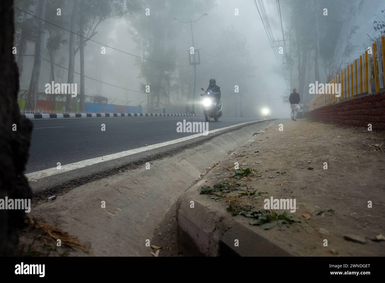 Feb.22nd 2024, Dehradun City Uttarakhand,India. Moving Traffic in Dense Fog with Headlights, Rajpur Road, Stock Photo