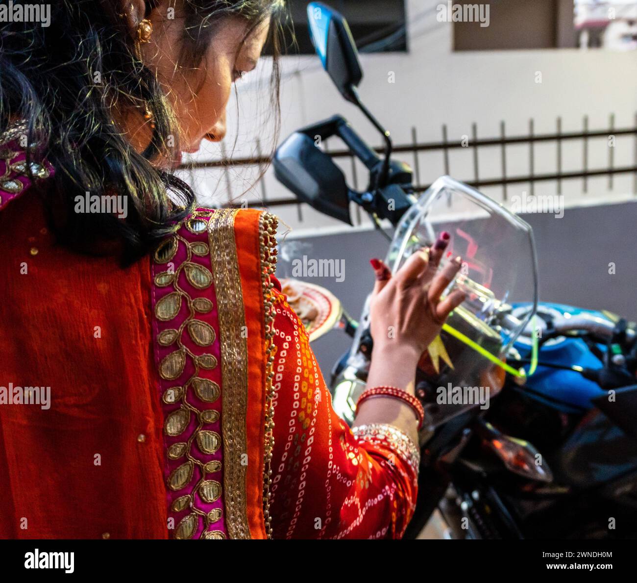 Jan.11th 2024, Uttarakhand India. Young Woman Performing Pooja and Traditional Rituals on New Vehicle During Dhanteras Festival, Stock Photo