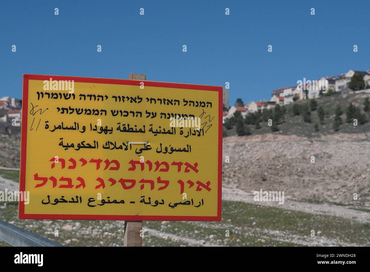 A sign that reads 'State lands must not be trespassed' placed by The Civil Administration, Israel's Governing Body in the West Bank, stands in the outskirts of the Israeli settlement of Ma'ale Adumim on February 29, 2024 in Ma'ale Adumim, West Bank. Israel Stock Photo