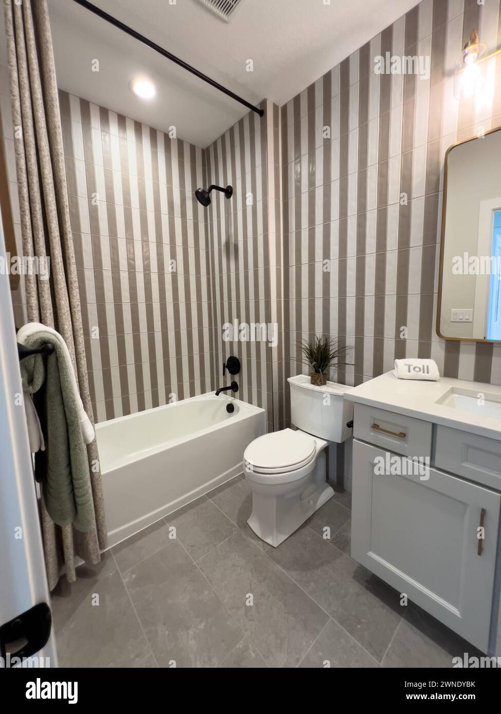 Sleek Bathroom Interior with Striped Wallpaper and Modern Fixtures ...