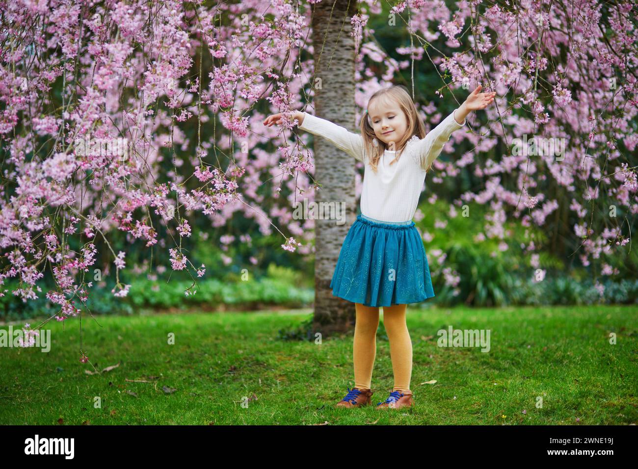 Adorable Preschooler Girl Enjoying Nice Spring Day In Park During adorable-preschooler-girl-enjoying-nice-spring-day-in-park-during