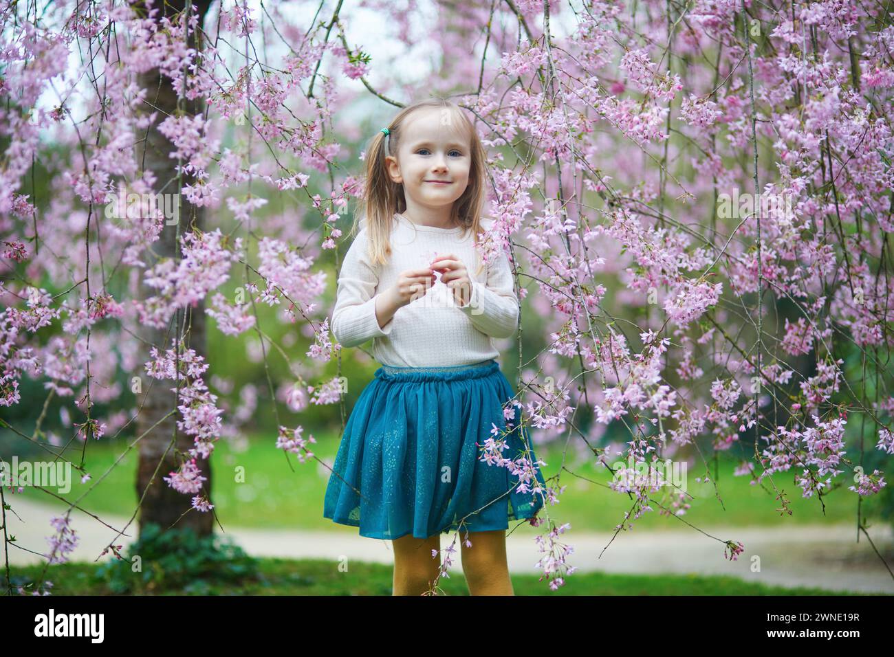 Springtime Kids Outside Adorable preschooler girl enjoying nice spring day in park during ...