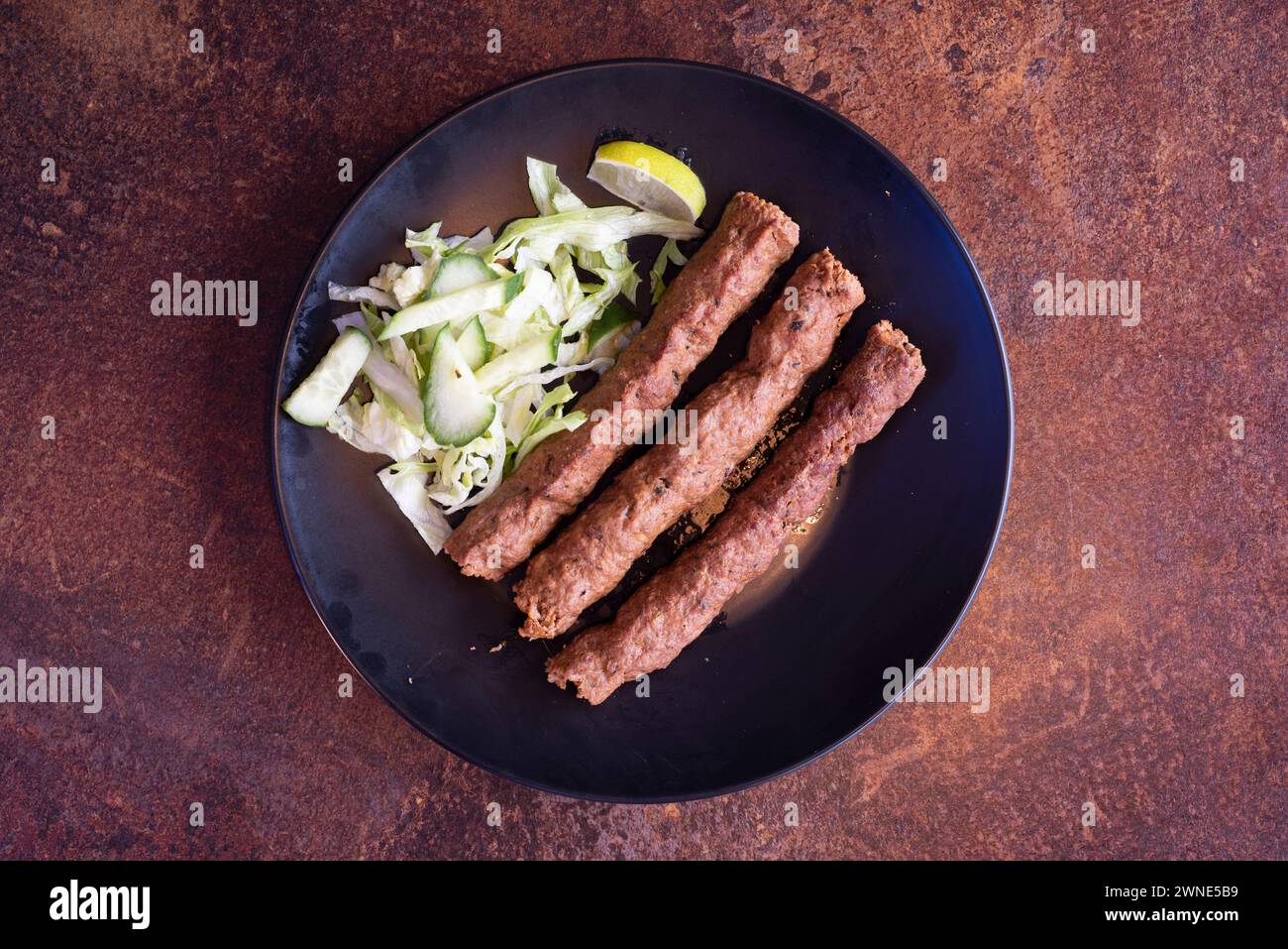 Lamb seekh kebabs spiced grilled meat and side salad Stock Photo