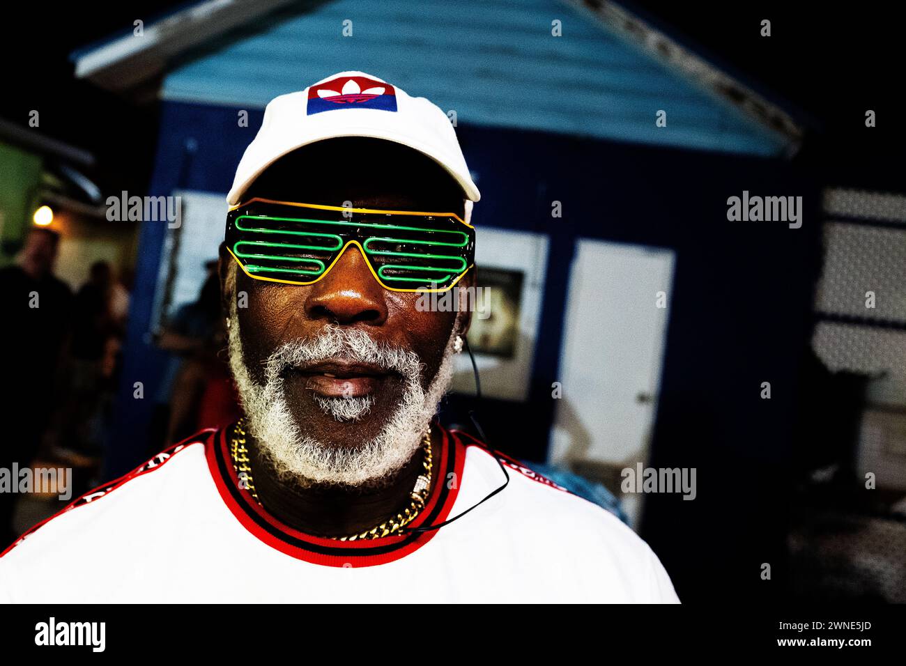 A market vendor adding to the carnival atmosphere at Oistins fish fry, a regular event every Friday in Barbados Stock Photo