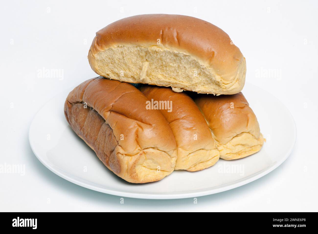 4 Organic Sweet Potato Bread  Rolls on a Plain White Plate Stock Photo