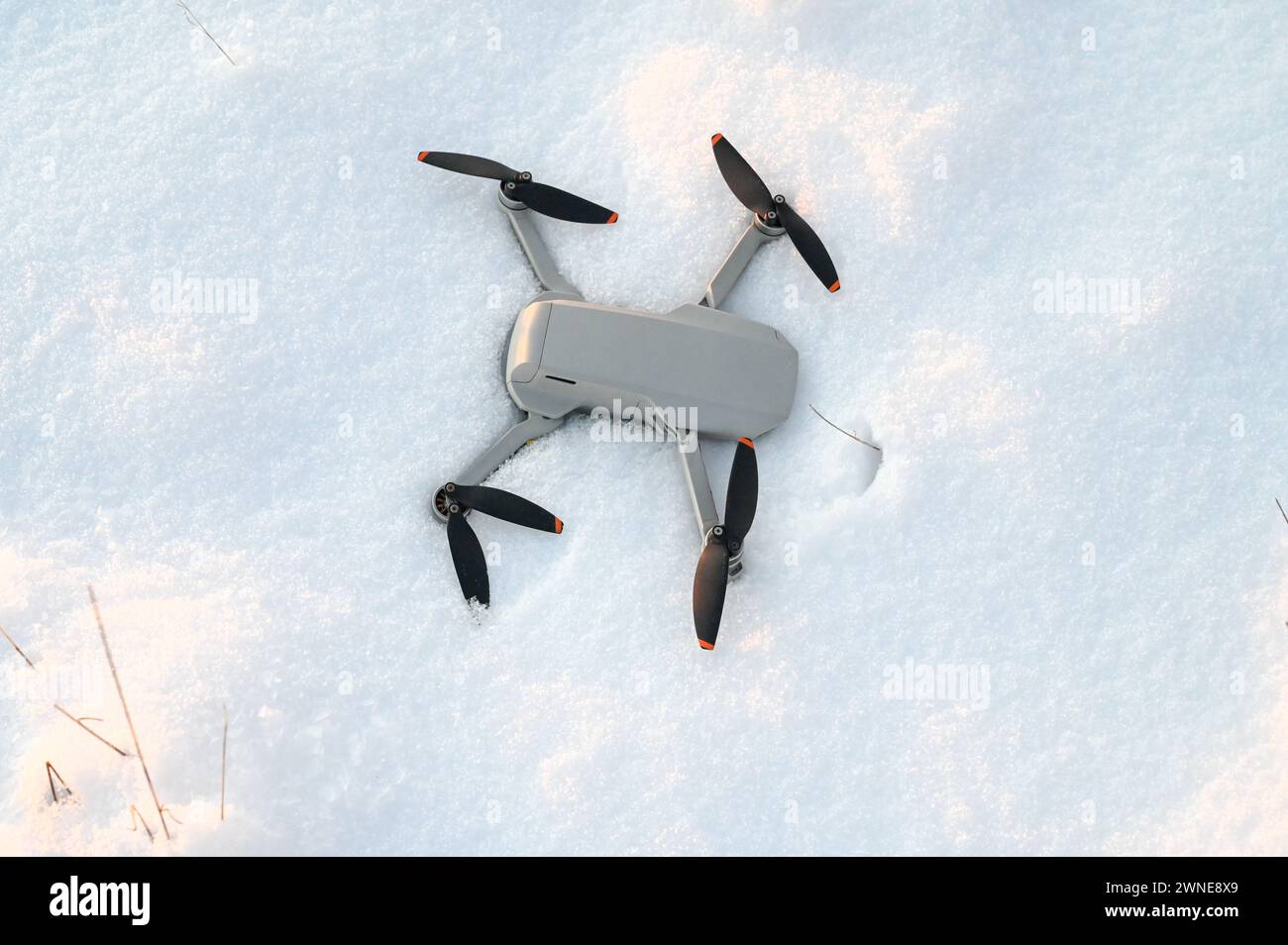 A drone lost in the snow. A drone that fell into the snow. Fail flight. Accident with a drone. Stock Photo