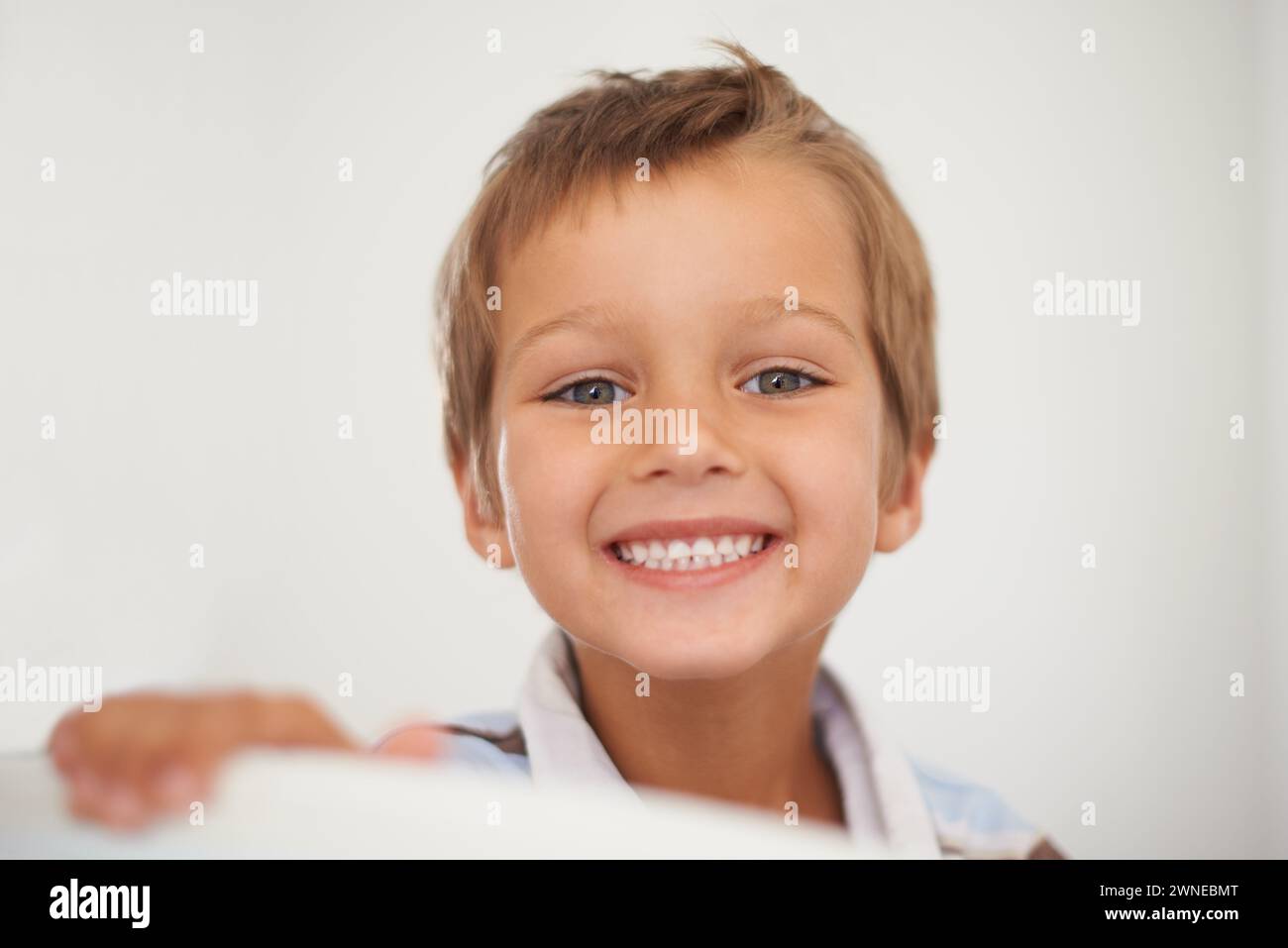 Portrait, happy and healthy boy for dental care in home, oral hygiene and growth or development of milk teeth. Child, strong and face for white smile Stock Photo