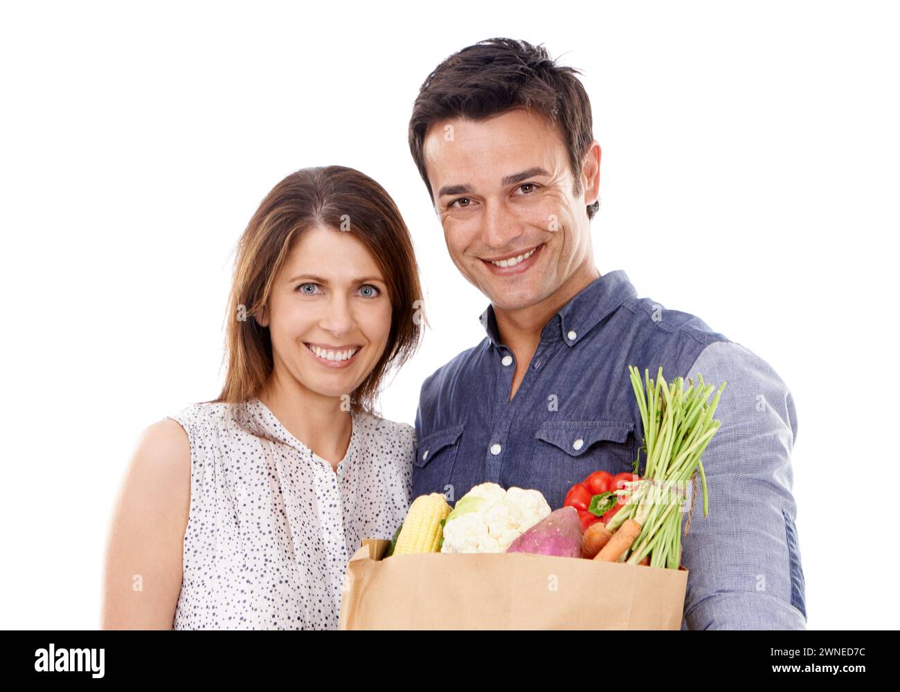 Happy couple, portrait and shopping bag with groceries for food, natural sustainability or nutrition on a white studio background. Young man and woman Stock Photo