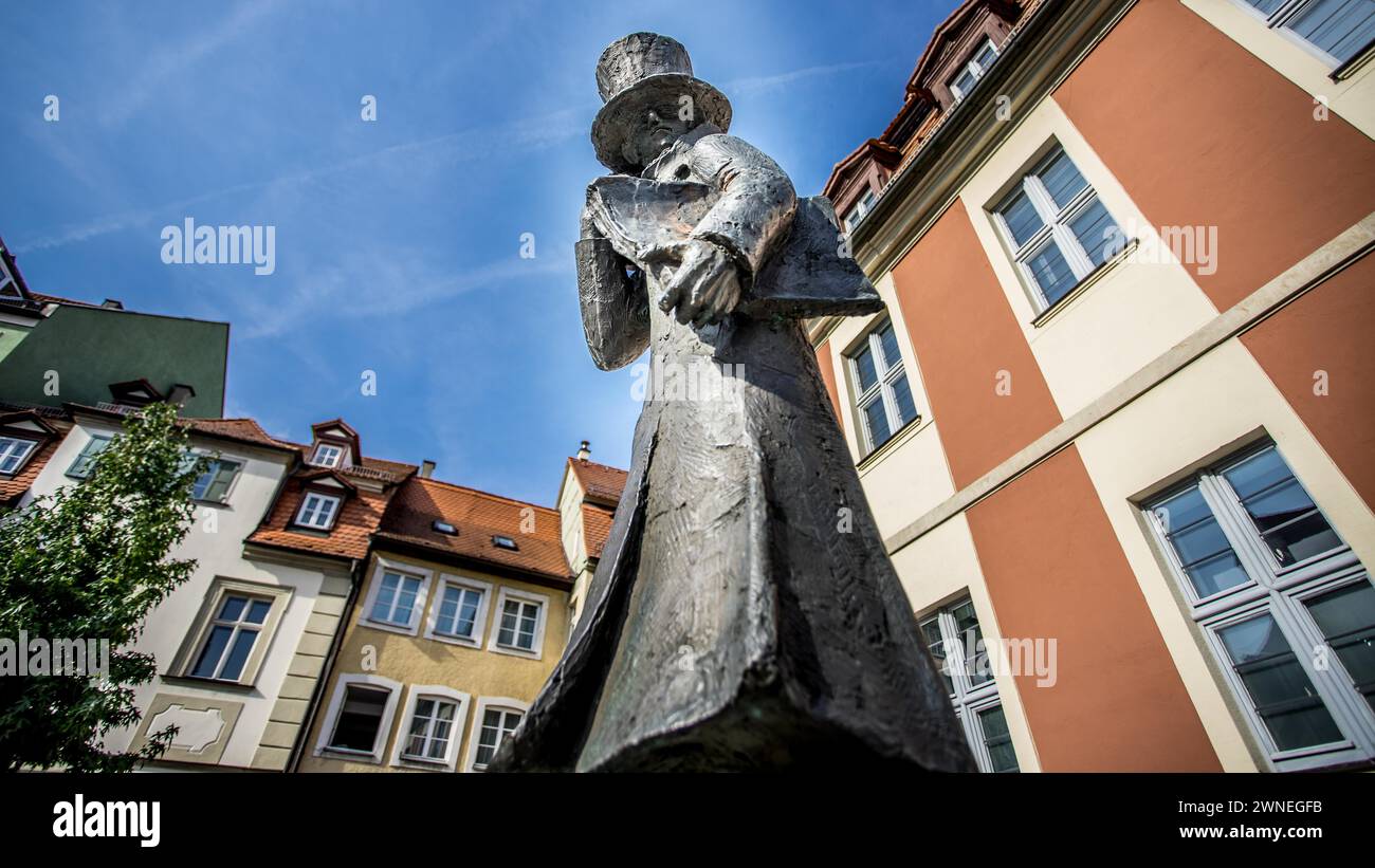 Statue with top hat in front of a backdrop of colourful historical ...