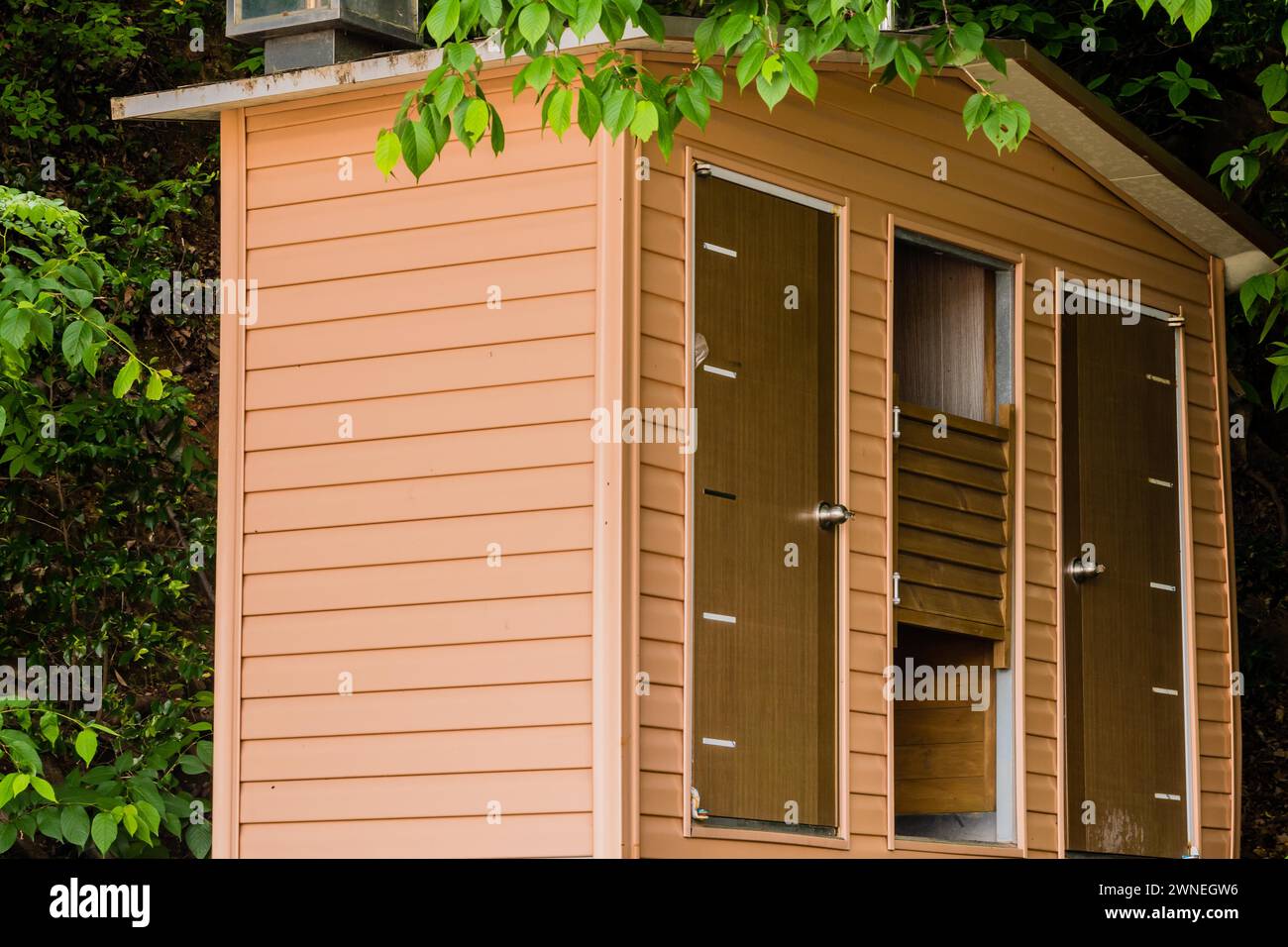 Closeup of wooden public toilets in a woodland park area in South Korea Stock Photo