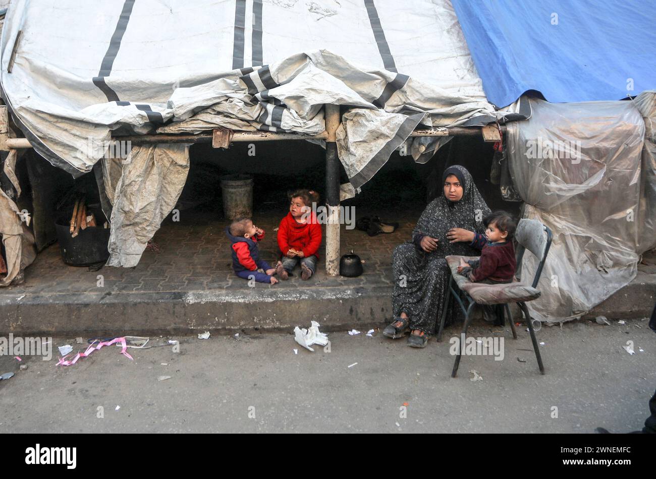 Rafah, Gaza. 29th Feb, 2024. Displaced Palestinian family sits outside ...