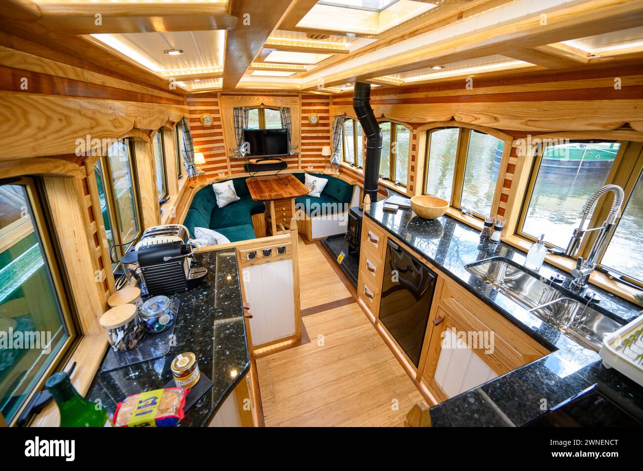 Eye catching interior of a holiday hire narrowboat with modern fixtures and fittings and distinictive wood patterns on the walls Stock Photo