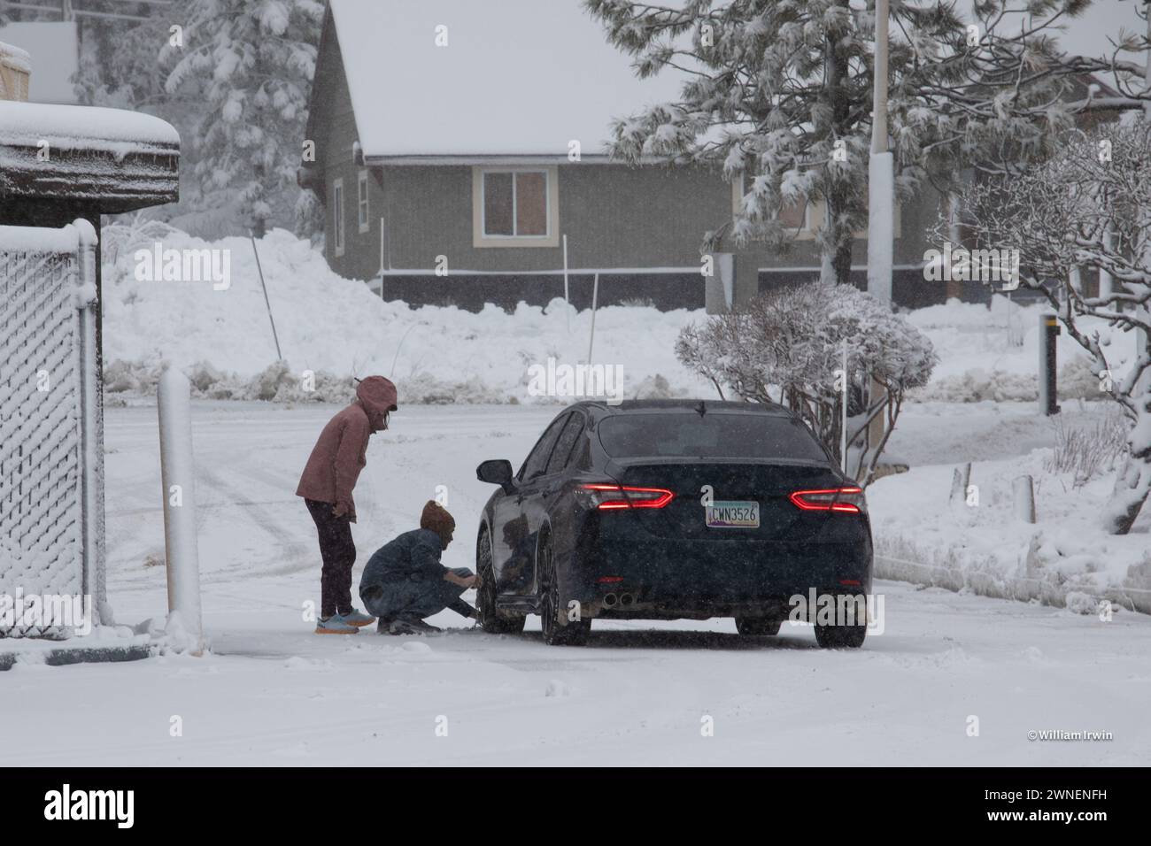 Truckee, USA. 01st Mar, 2024. People put on chains before the winter